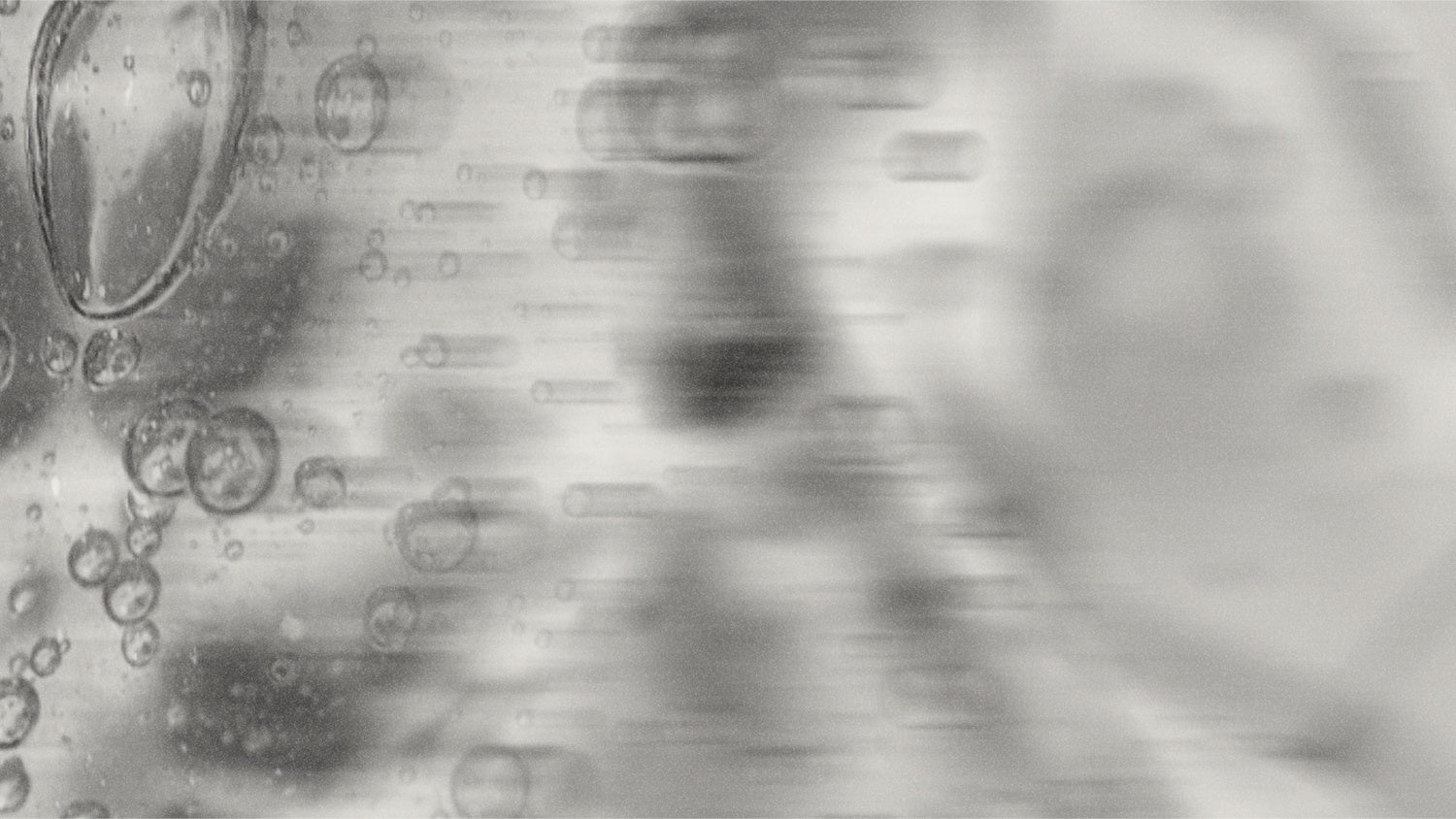 Bubbles suspended in clear liquid, abstract microscopy.